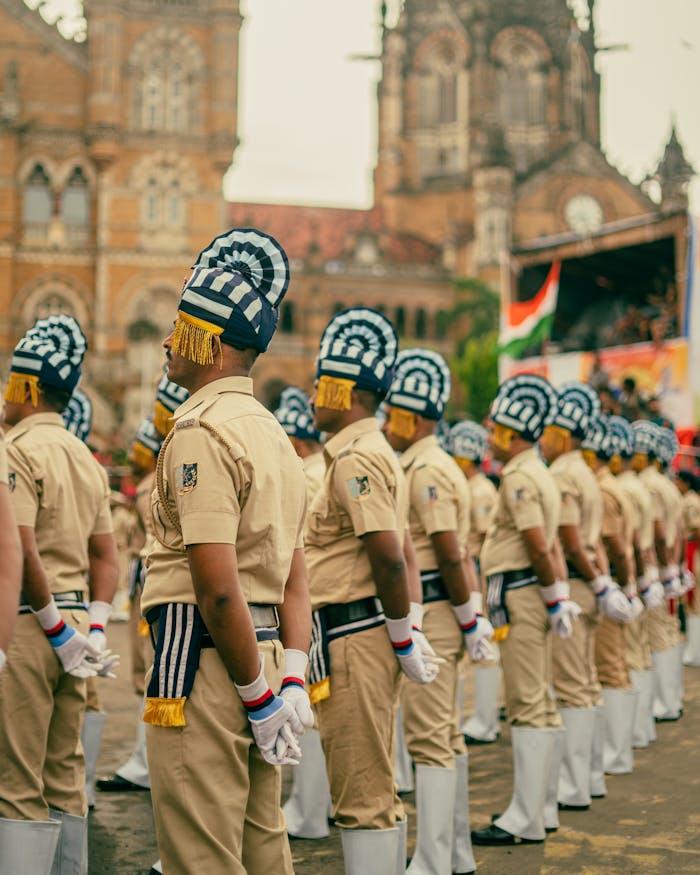 Police officers in ceremonial uniforms at CST Mumbai during a parade event.